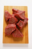 Diced beef on chopping board