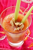 Carrot and mango juice with walnuts and celery