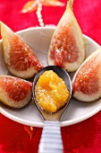 Figs with a spoonful of mango sauce