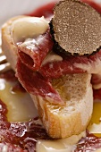 Toast with beef carpaccio, mayonnaise and truffle