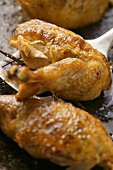 Crispy roast chicken legs on baking tray