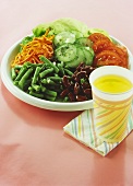 Mixed vegetable salad on plate; lemonade