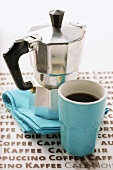 Blue espresso cup in front of espresso machine