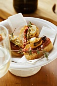 Crostini with seafood and dried tomatoes; wine