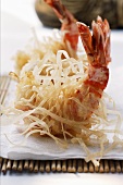 King prawns, fried in rice noodles, on bamboo mat