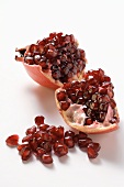 Pomegranate, halved, and pomegranate seeds