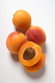 Four apricots, one halved