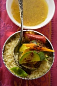 Couscous with vegetables and cinnamon in silver bowl