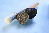 Black truffle, halved, with truffle brush