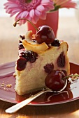 Piece of cheesecake with cherries and coconut shavings