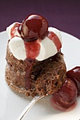 Chocolate soufflé with cream and cherries