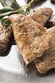 Fried calf's liver with sage in frying pan