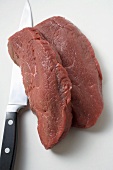 Two slices of beef sirloin with knife