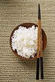 Bowl of rice and chopsticks