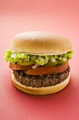 Hamburger with tomato, gherkin, onions and lettuce