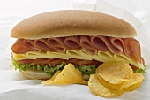 Sub sandwich and crisps on sandwich wrap