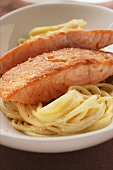 Fried salmon fillets on spaghetti