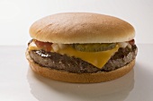 Cheeseburger with gherkin, onions and ketchup