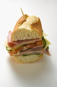 Baguette with ham, cheese, tomato, cucumber with toothpick