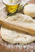 Rolled out & ball of dough, rolling pin, olive oil & branch