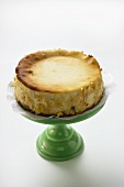 Cheesecake with flaked almonds on cake stand