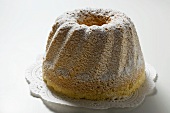 Ring cake with icing sugar on doily