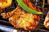 Barbecued pork chop with chili on the barbecue