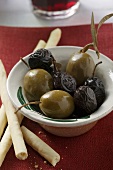 Black and green olives with grissini