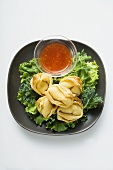 Deep-fried wontons with sweet and sour sauce