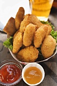 Chicken Nuggets in cardboard dish, ketchup & sweet & sour sauce