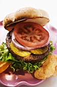 Home-made hamburger with gherkins, onions, tomato