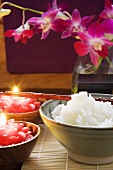Bowl of rice beside burning candles (Thailand)