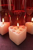 Burning heart-shaped candles for Valentine's Day