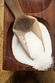 Salt in wooden bowl with scoop