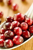 Several cranberries on spoon