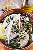 Fish fillets in olive oil with capers