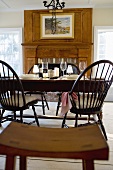 Laid table with red wine in front of fireplace