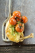 Fried chicken breast with cherry tomatoes on spatula