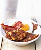 Potato pancake with fried egg and bacon