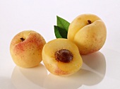 Two whole apricots and half an apricot