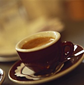 A cup of espresso with a spoon in the saucer