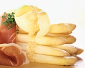 White asparagus with smoked ham and melting butter curl