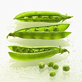 Three pea pods with single peas beside them