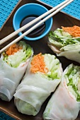 Rice paper rolls with soy dip and chopsticks