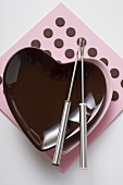Heart-shaped bowl with fondue forks