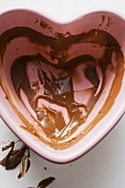 Heart-shaped bowl with remains of chocolate sauce