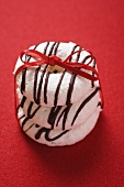 Almond and coffee macaroons tied with red gift ribbon