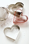 Heart-shaped biscuit cutters with flour