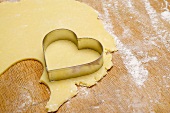 Cutting out a heart-shaped biscuit