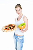Young woman with pizza and salad